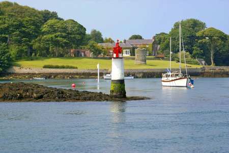 Island at a town of Ireland, with lighthouse and country houseの写真素材
