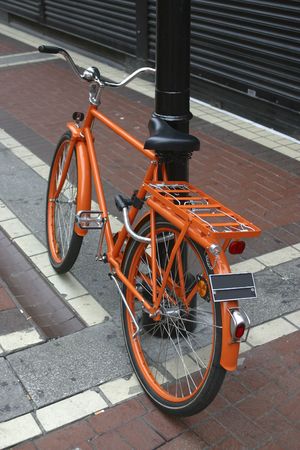 Orange bicycle tied a streetlamp on the street, in Dublin, Irelandの写真素材