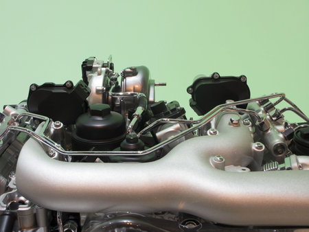 Modern car engine on green background.
