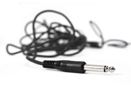 Macro shot of wire with audio headphone connection plug.