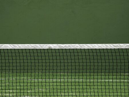 Net of paddle court on green wall background.の写真素材
