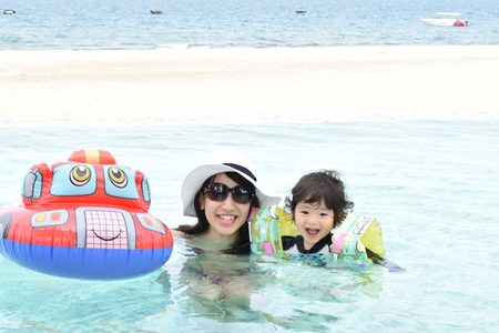 playing mother and baby at poolの写真素材