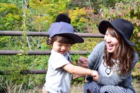 young japanese mother is playing with her sonの写真素材