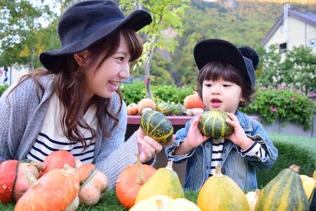halloween mother and son with colorful pumpkinの写真素材