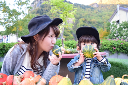 halloween mother and son with colorful pumpkinの写真素材