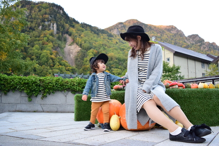 halloween mother and son with colorful pumpkinの写真素材