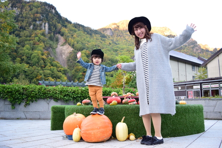 halloween mother and son with colorful pumpkinの写真素材