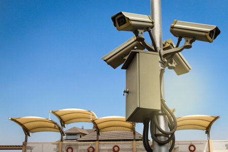 CCTV monitoring against blur of people at a swimming pool background.