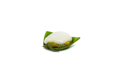Thai pudding with corn and coconut topping on white background.
