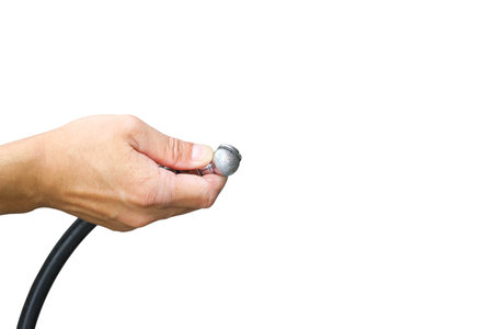 Close up a man hand holding tire inflation head for checking air pressure and filling air in the...