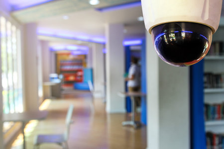 CCTV security camera or surveillance system in modern office building with blurred background