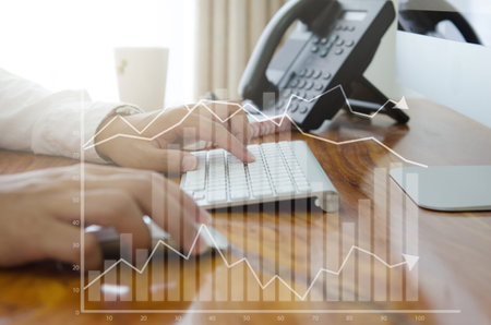 Close up man working with computer and digital visual graph pop up