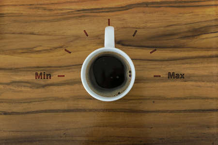 Cup of coffee and gage volume concept on wooden tableの写真素材