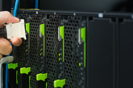 Hand connecting console to server in data centerの写真素材