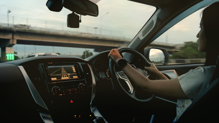 Woman drive a modern car on the road.の写真素材