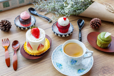 tea cup and cupcake and decoration placed on a wooden table.の写真素材