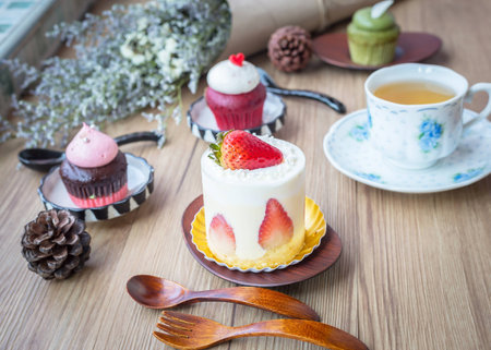 tea cup and cupcake and decoration placed on a wooden table ;Vintage style.の写真素材