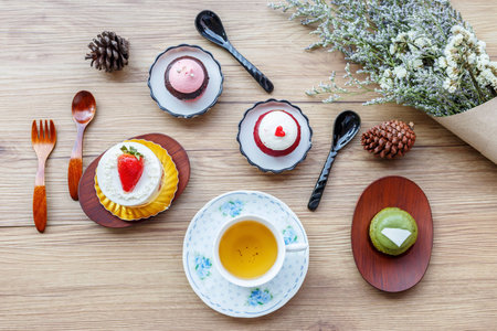 tea cup and cupcake and decoration placed on a wooden table.の写真素材
