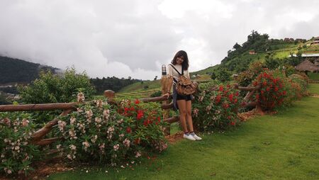 Lovely young woman with beautiful smile in the fresh garden in the morningの写真素材