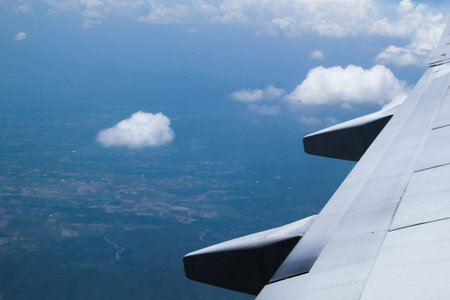 Looking through window aircraft during flight in wing with a nice blue skyの写真素材
