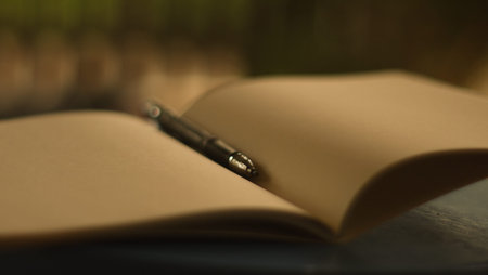 Close-up of open book and pen