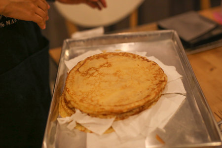 A young women is making Crepe Cake in the kitchen.
