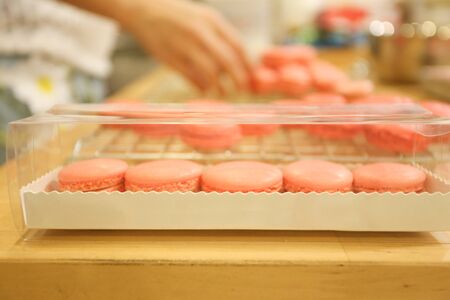 woman enjoy to packing macarons at home, top view, retro tonedの写真素材