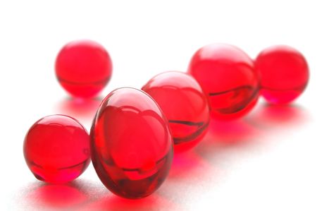 Close up of vitamins E pills, red capsulesの写真素材