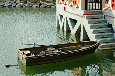 A rowboat anchored beside an antique marina