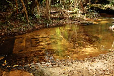 Sculpted stone under water at Kbal Speana, Cambodiaの写真素材