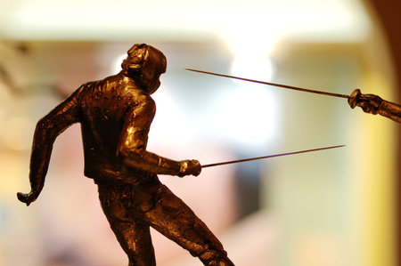 The fencing statues in action of attacking