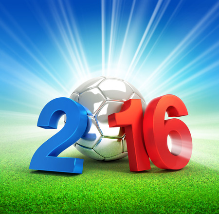 2016 year illustrated with a silver soccer ball, illuminated on a grass fieldの写真素材