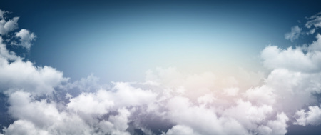 Stormy sky background, sunlight through white cloudsの写真素材