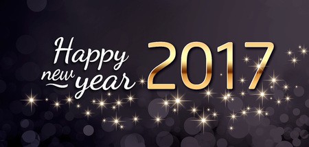 Gold 2017 year type and greetings on a festive black background with star lightsの写真素材