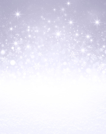 Falling snowflakes, white snow and bright light on a glittering silver colored backgroundの写真素材
