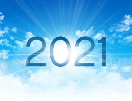 New Year 2021 date number, high in blue sky with morning sunrise, as the beginning of a new dayの写真素材