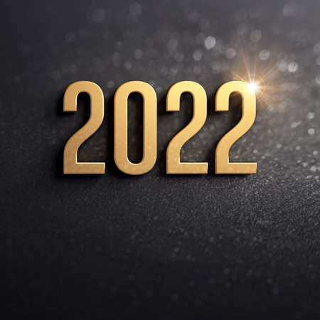 New year greeting card 2022. Date number colored in gold on a glittering black backgroundの写真素材