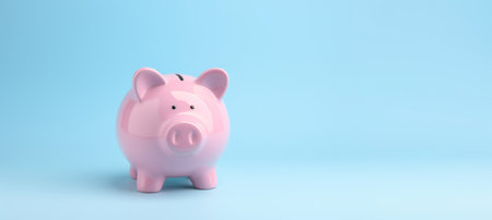 Pink pig piggy bank isolated on blue background - Generative AIの素材