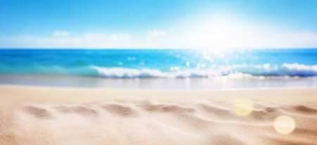 Sand beach and clear blue sea under the heat of the sun, with defocused background. Summer holiday mood banner.の素材