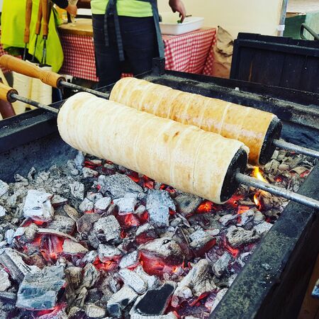 Hungarian Chimney Cakes Cooking over Open Coalsの写真素材