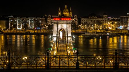 The Iconic Chain Bridge in Budapest all dressed up in the colors of the Hungarian Flag to celebrate the Revolution of 1848 against the Austrians.の写真素材