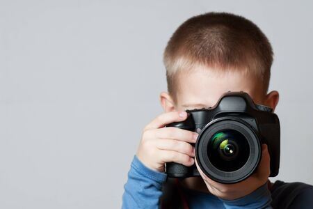 Little Boy holding camera and taking photoの写真素材