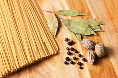 raw pasta on wood background textureの写真素材