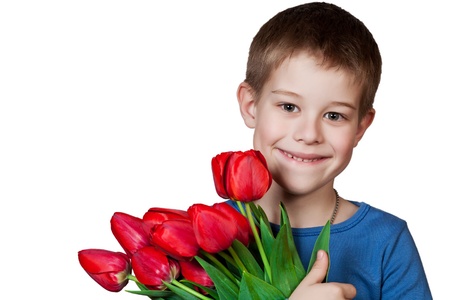 Young boy holding bouquet of tulips isolated on whiteの写真素材