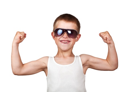 Thin boy showing his muscles isolated on white backgroundの写真素材