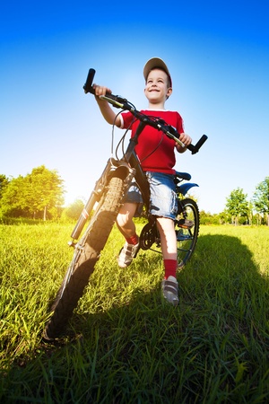 Six  year old boy on a bike on a beautiful sunny meadowの写真素材