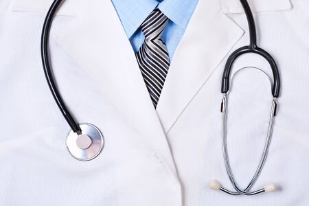 Close up of a doctors lab white coat with stethoscopeの写真素材