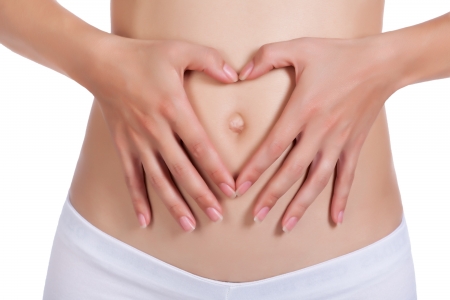 Beautiful female body with heart sign isolated on whiteの写真素材