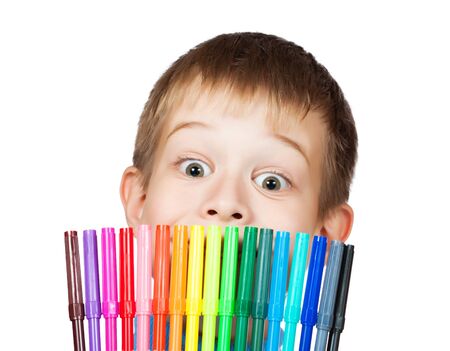 cheerful boy with a felt-tip pen before his faceの写真素材