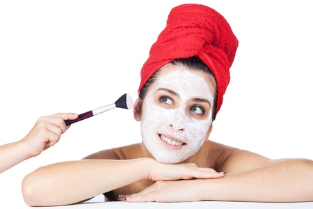 Beautiful woman in towel with facial maskの写真素材